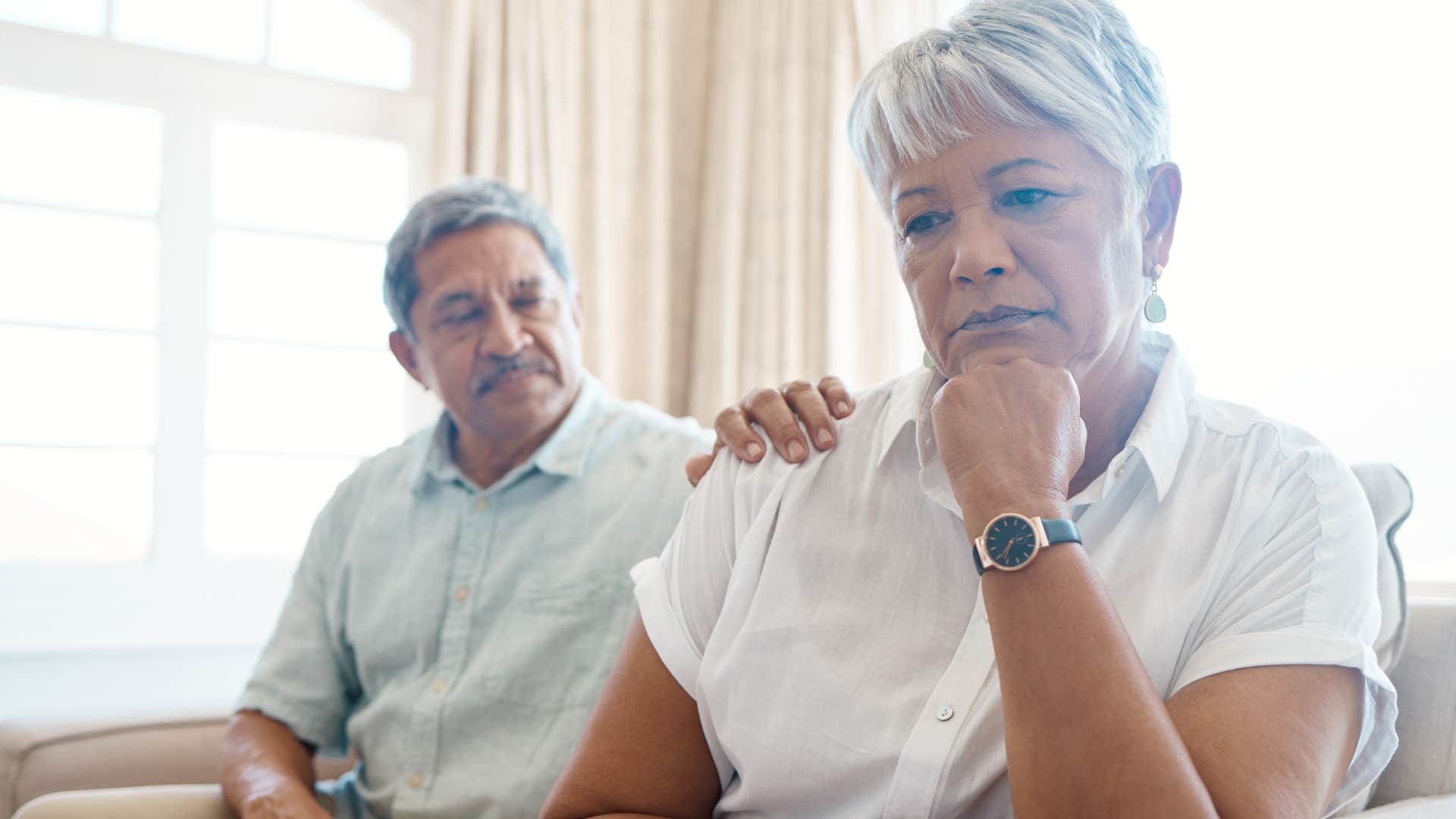 emotionally exhausted woman turned away from her husband avoiding vulnerability