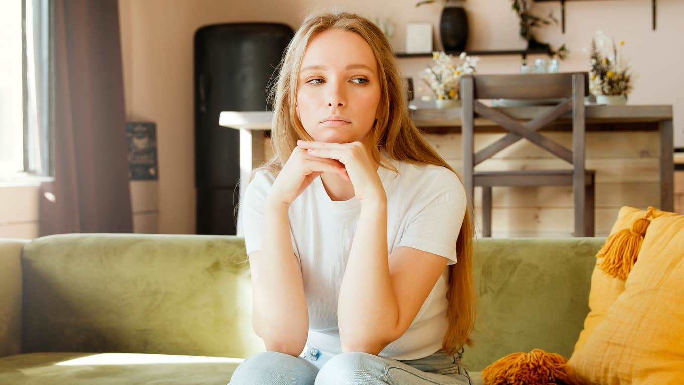 emotionally exhausted woman in a daze at home