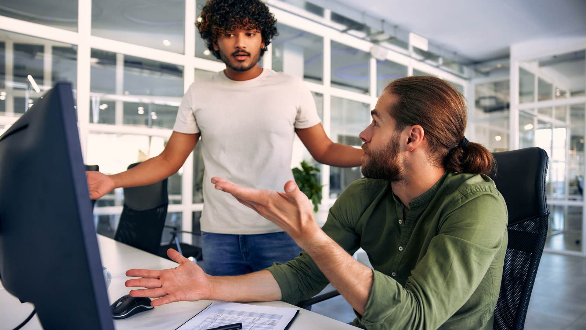 exhausted man at work with complicated relationship with coworker