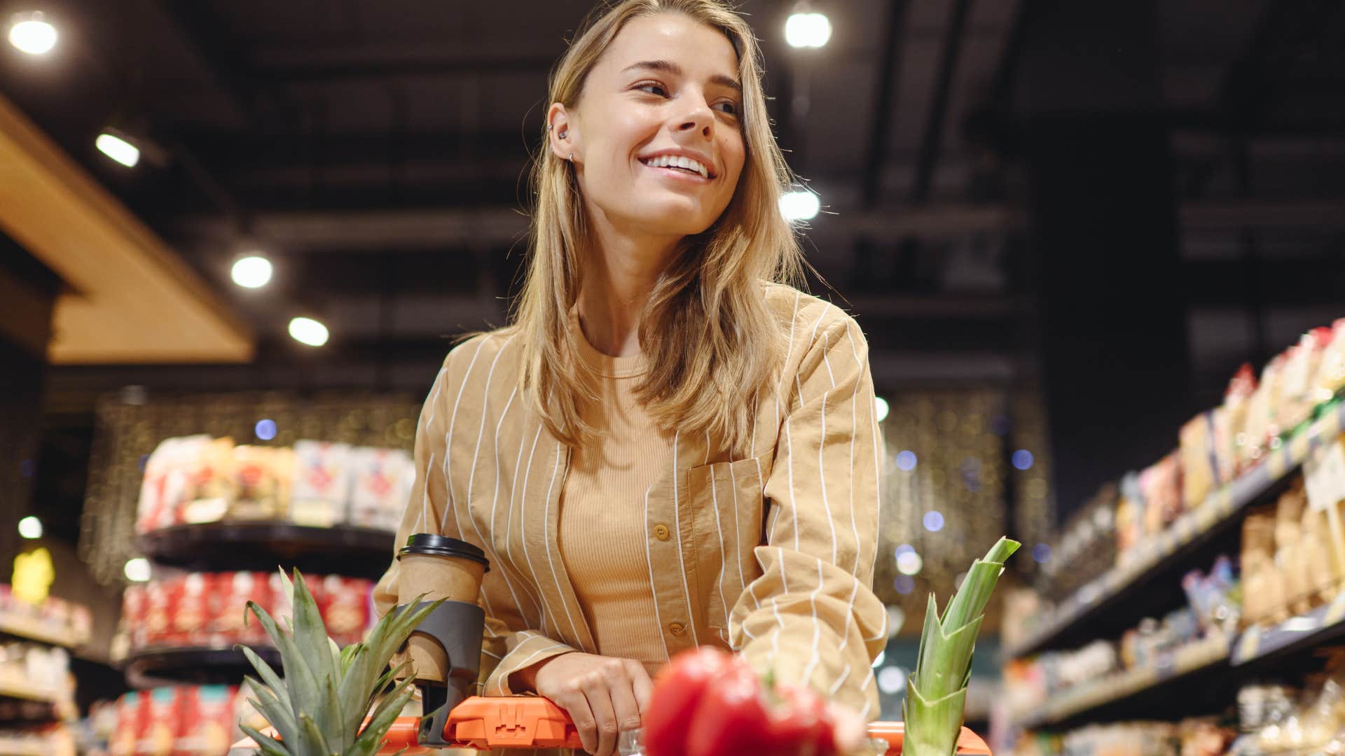 Woman grocery shopping without a plan at the store.