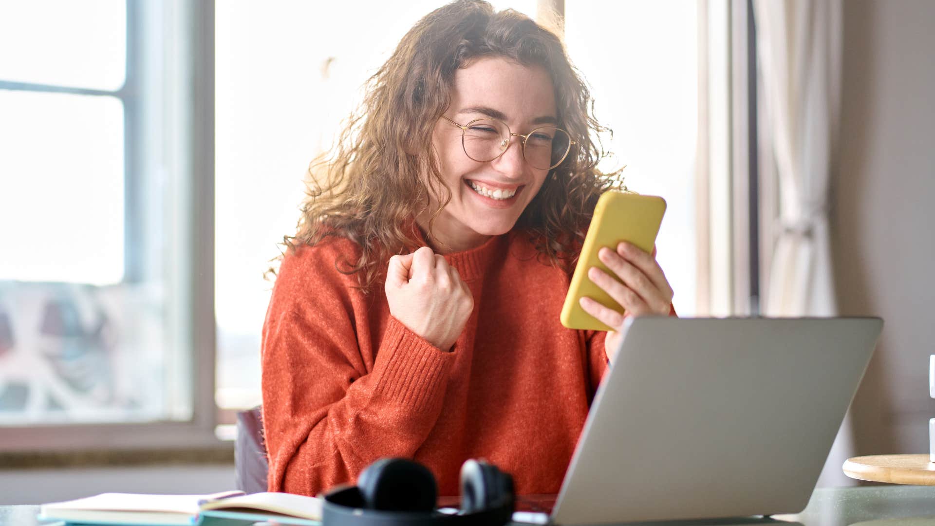 Woman smiling after getting a new phone every year.