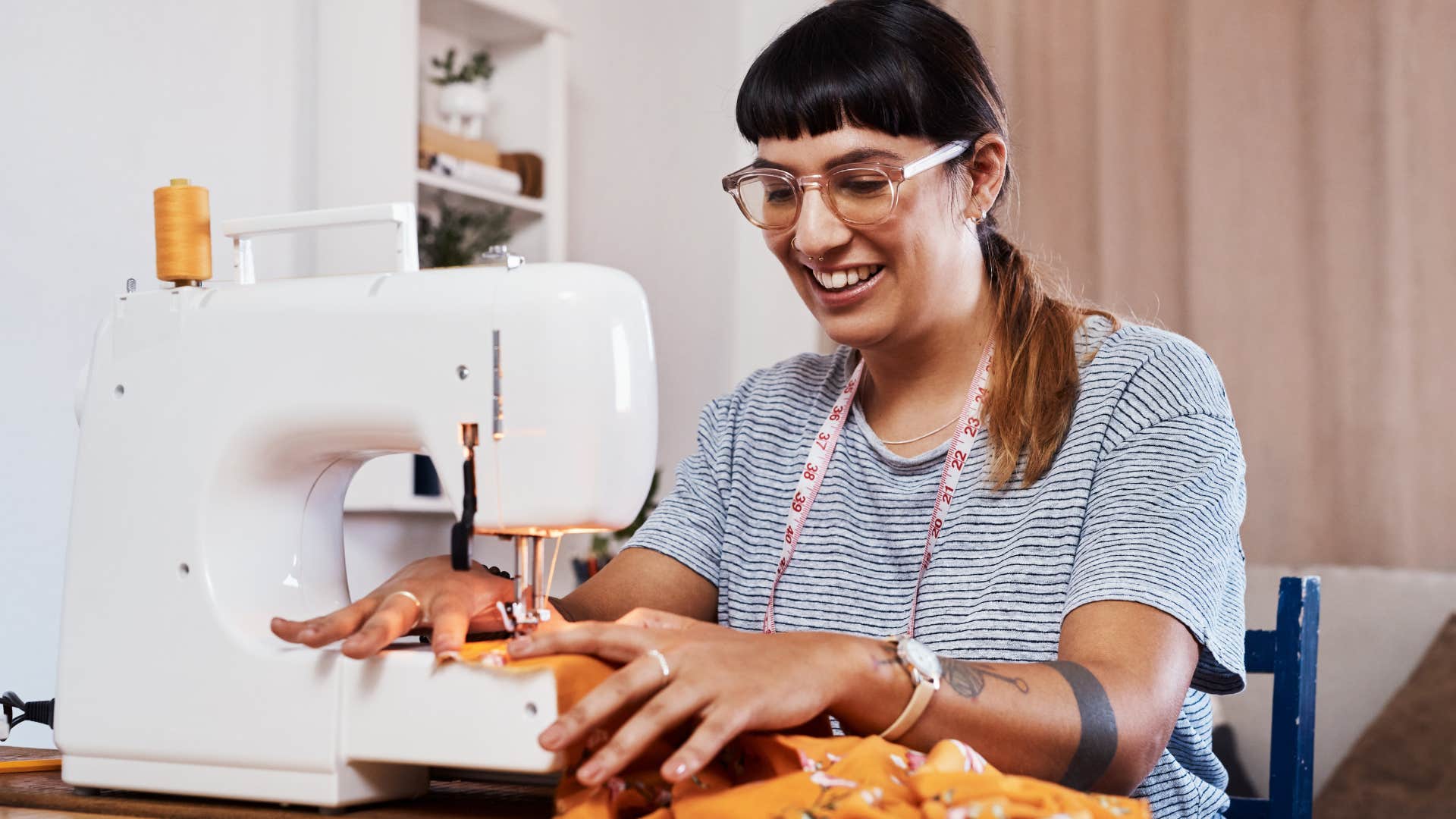 woman sewing clothes that are worn or ripped