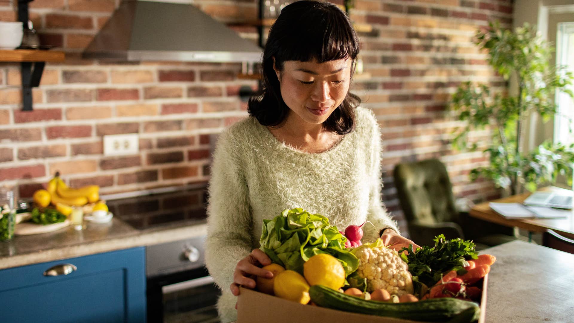 rich woman unpacking specialty groceries at home