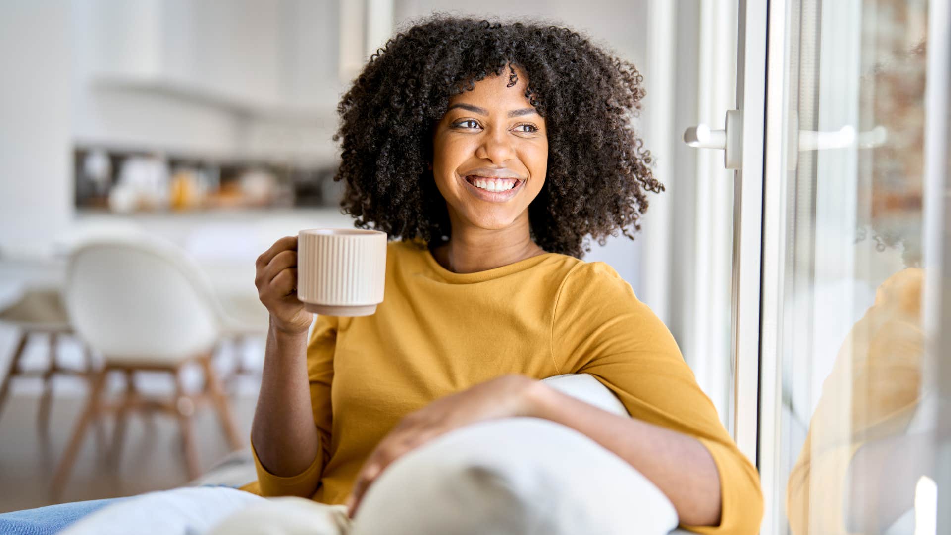 woman drinking coffee smiling