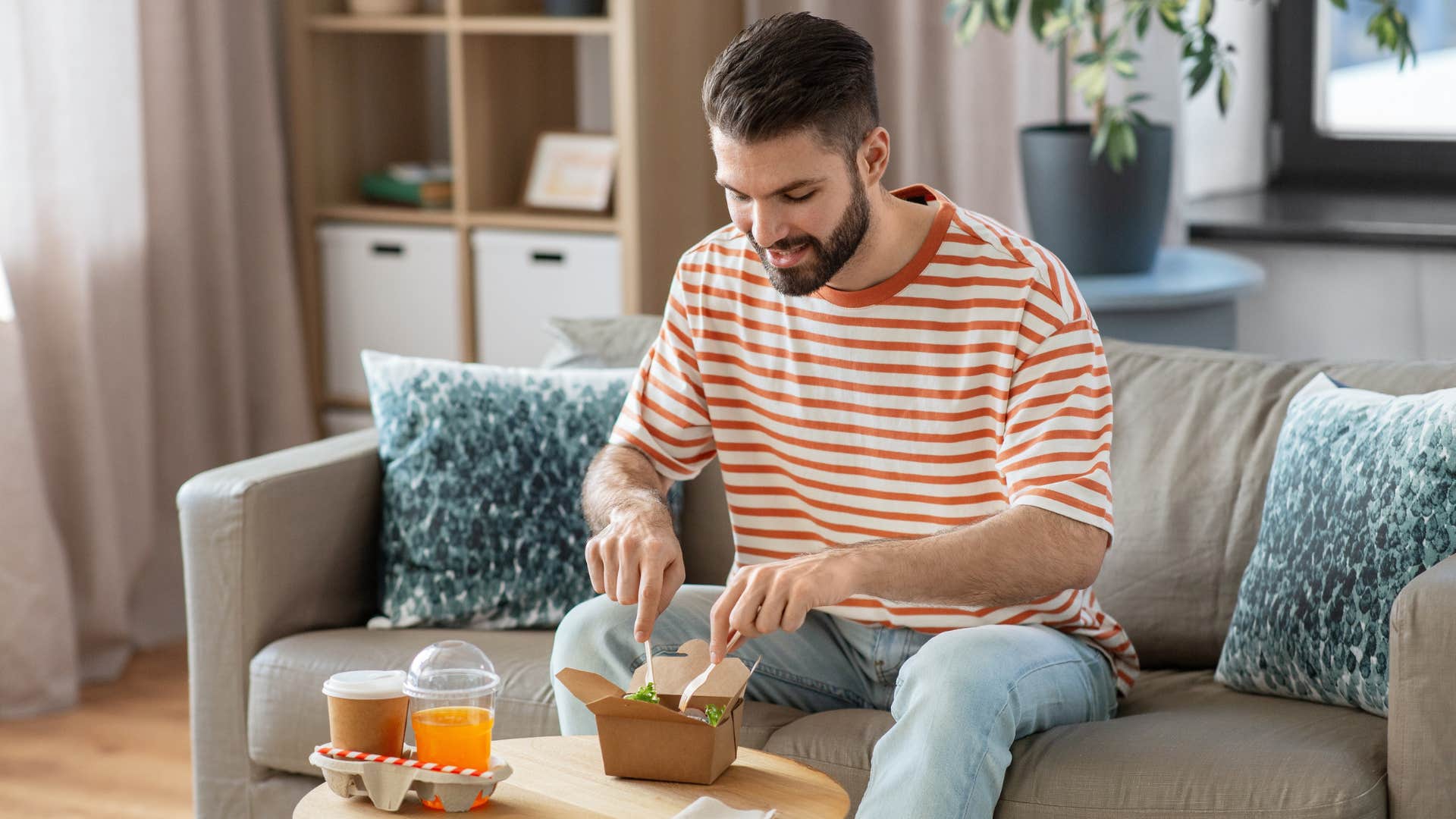 man eating dinner with plastic utensils