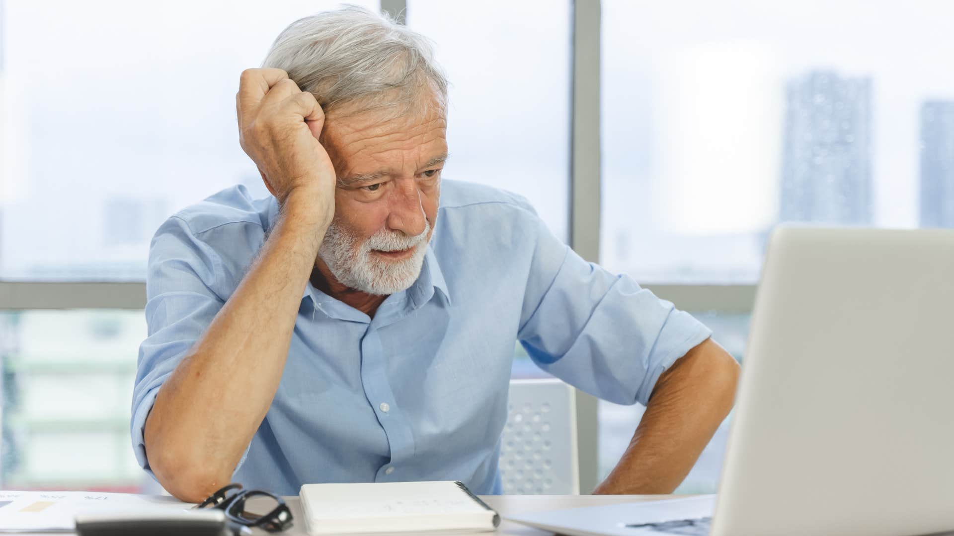 frustrated older man refusing to pay for an extended warranty