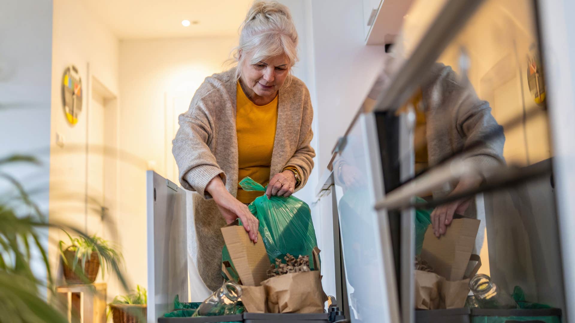 elderly woman taking out the trash instead of paying for valet trash pick up