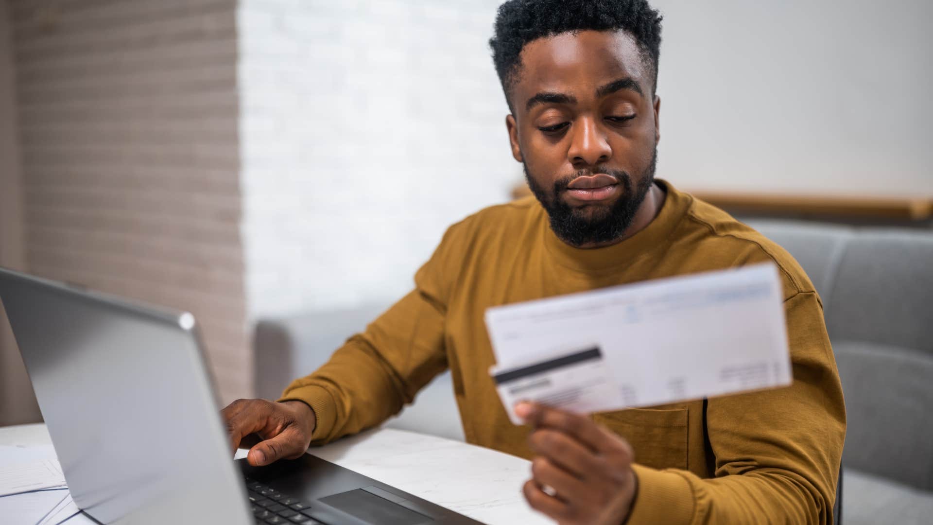 man looking at credit card bill