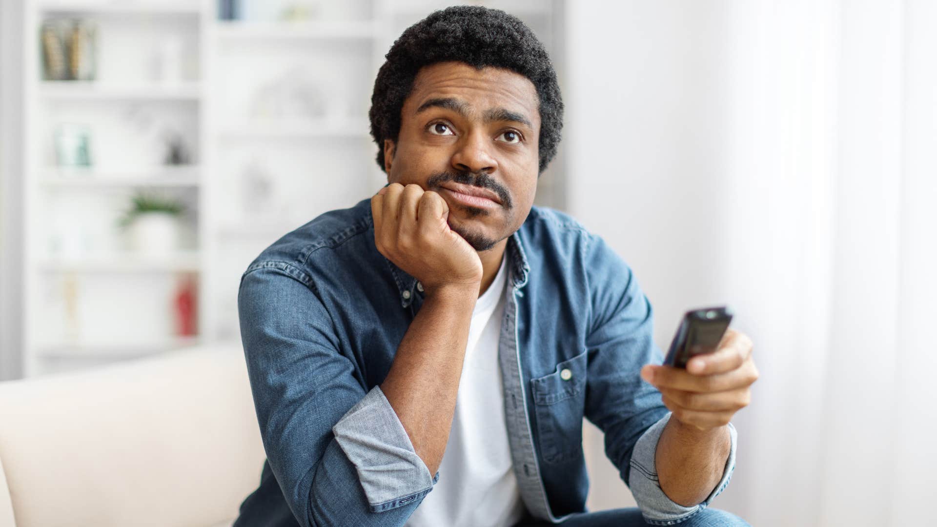 man flipping through channels after canceling cable