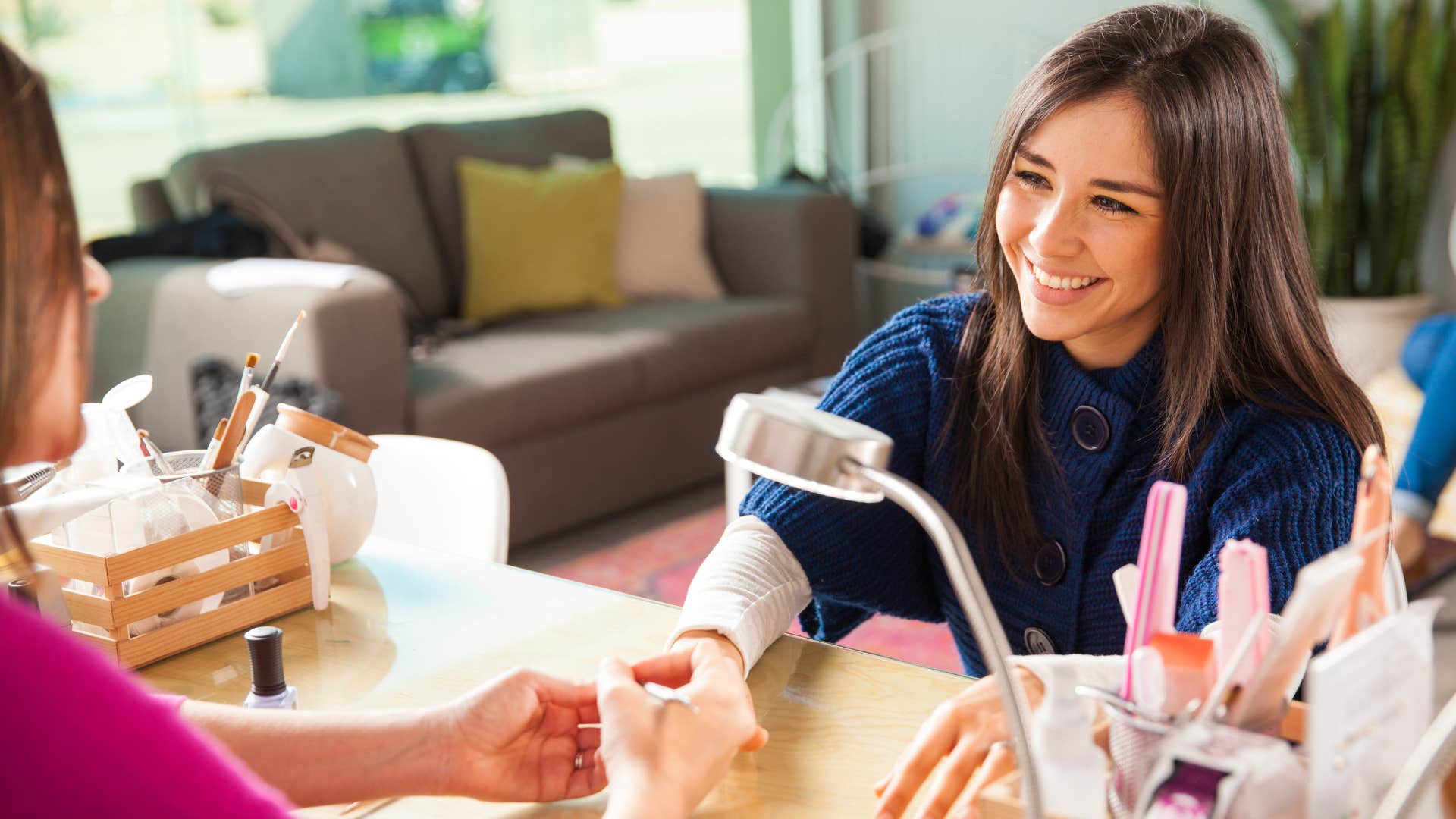 woman getting a manicure at the nail salon