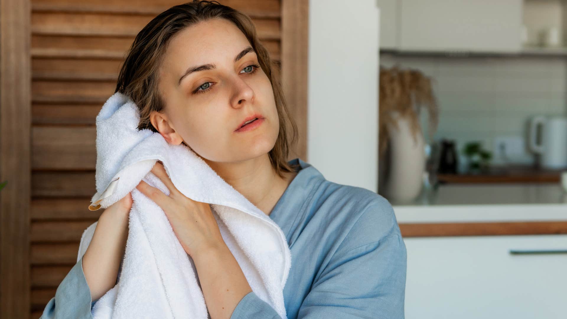 woman drying her hair with a towel