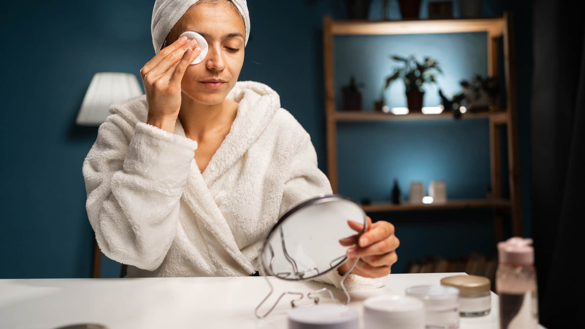 woman taking off her makeup with a single-use wipe