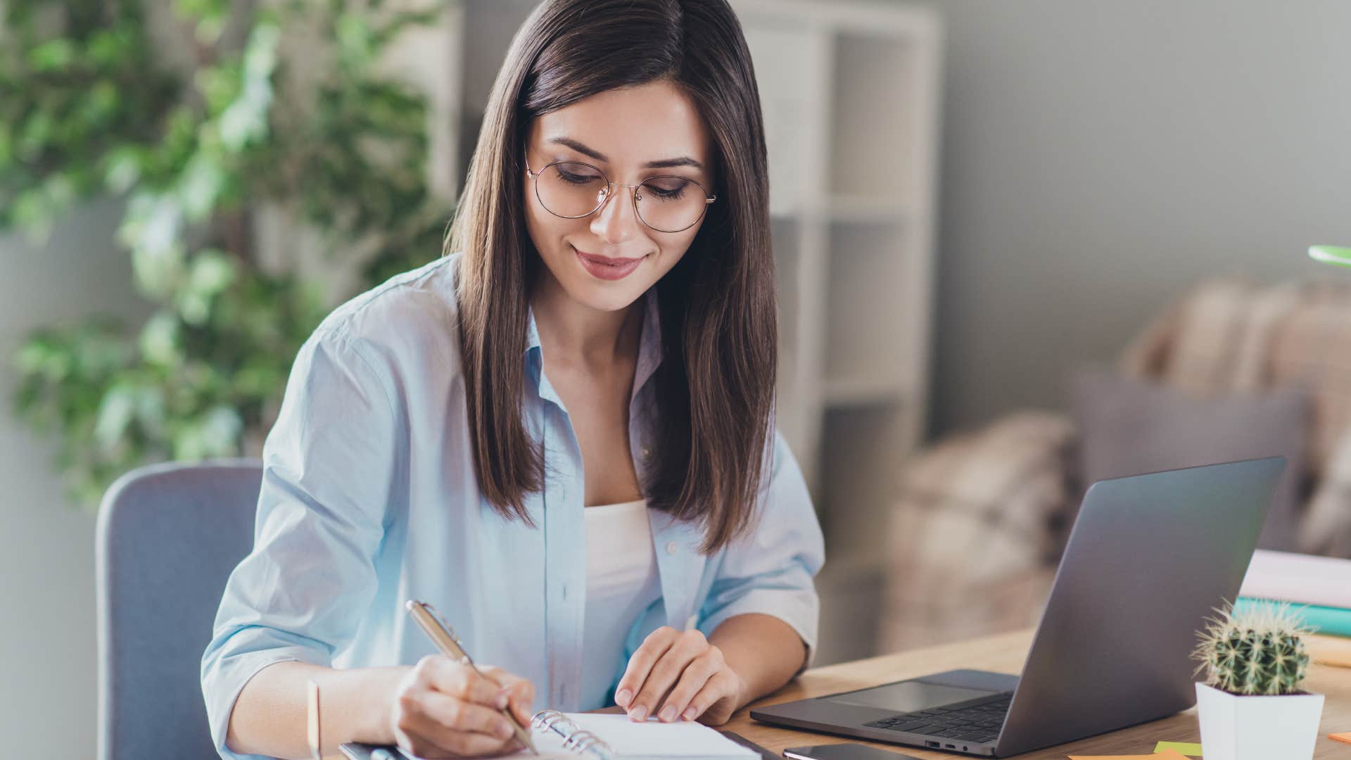woman writing in notebook