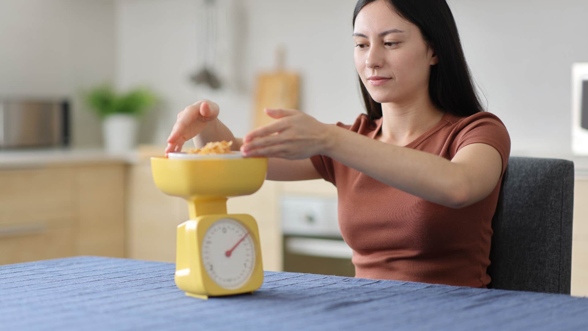 woman measuring food on a scale