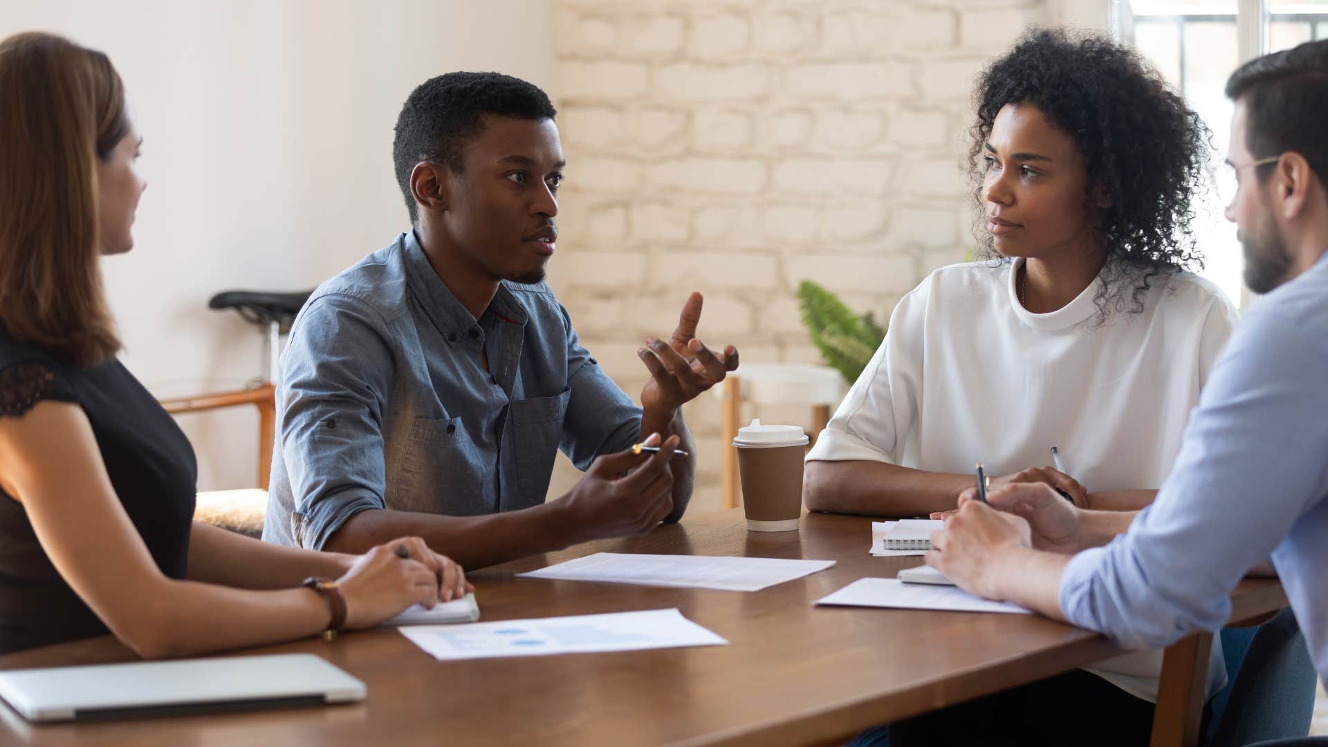 man in blue shirt asking during a meeting can we do this remotely while everyone stares at him