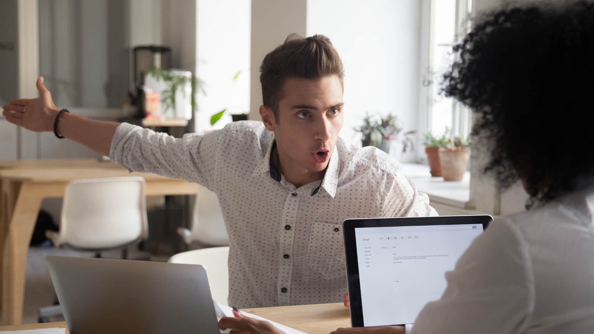 man pointing someplace and angrily saying i was only a few minutes late to woman