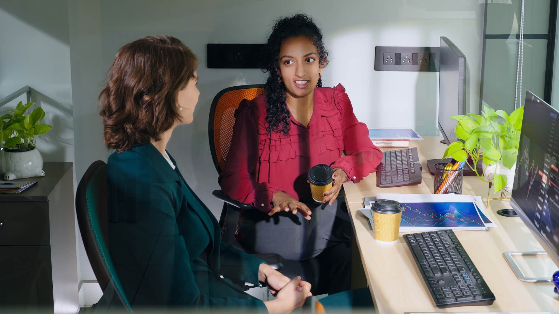 woman in red telling woman in dark clothing i'm sorry i don't do well under pressure