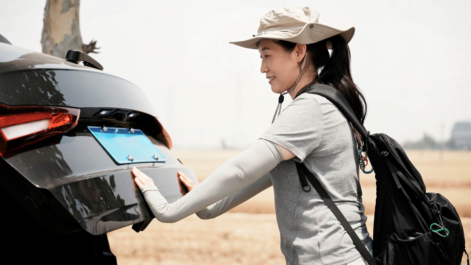 boomer woman looking at her custom license plate
