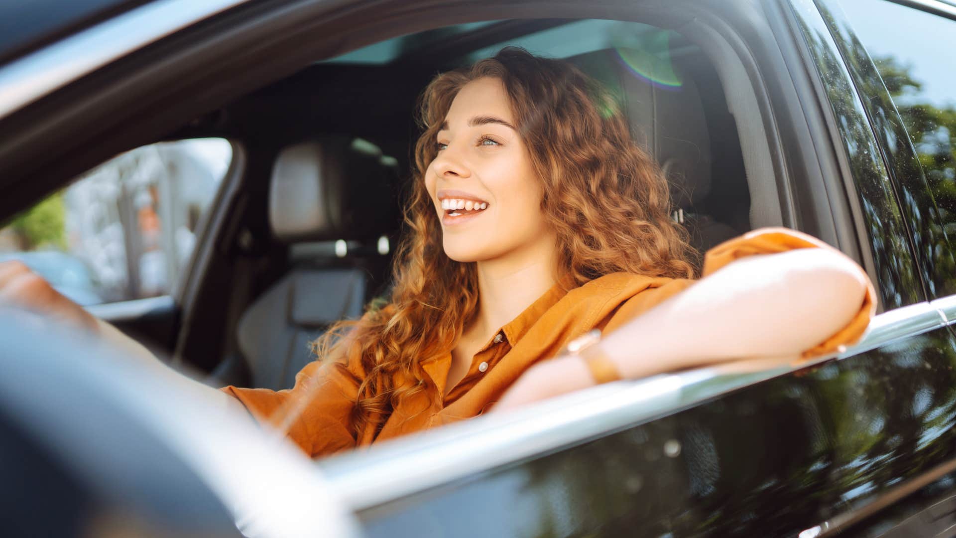 boomer woman about to drive car into garage using door opener