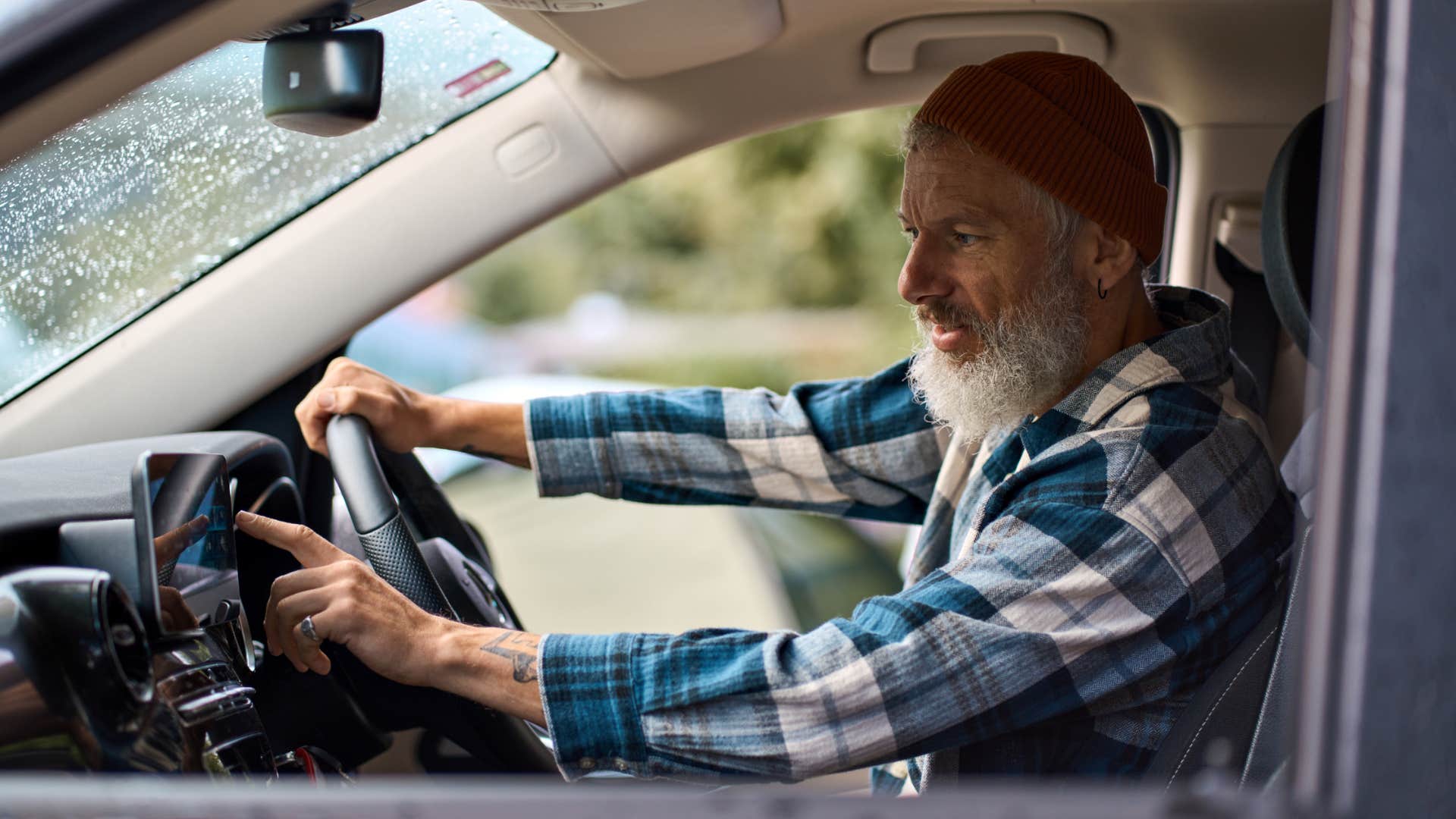 boomer man using outdated gps system in his car