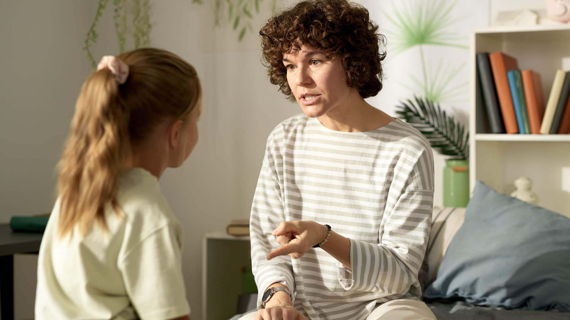 mom gossiping about other people to her young daughter