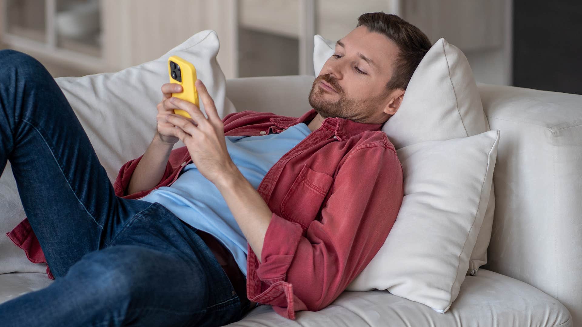 Man scrolling on his phone looking at online drama.