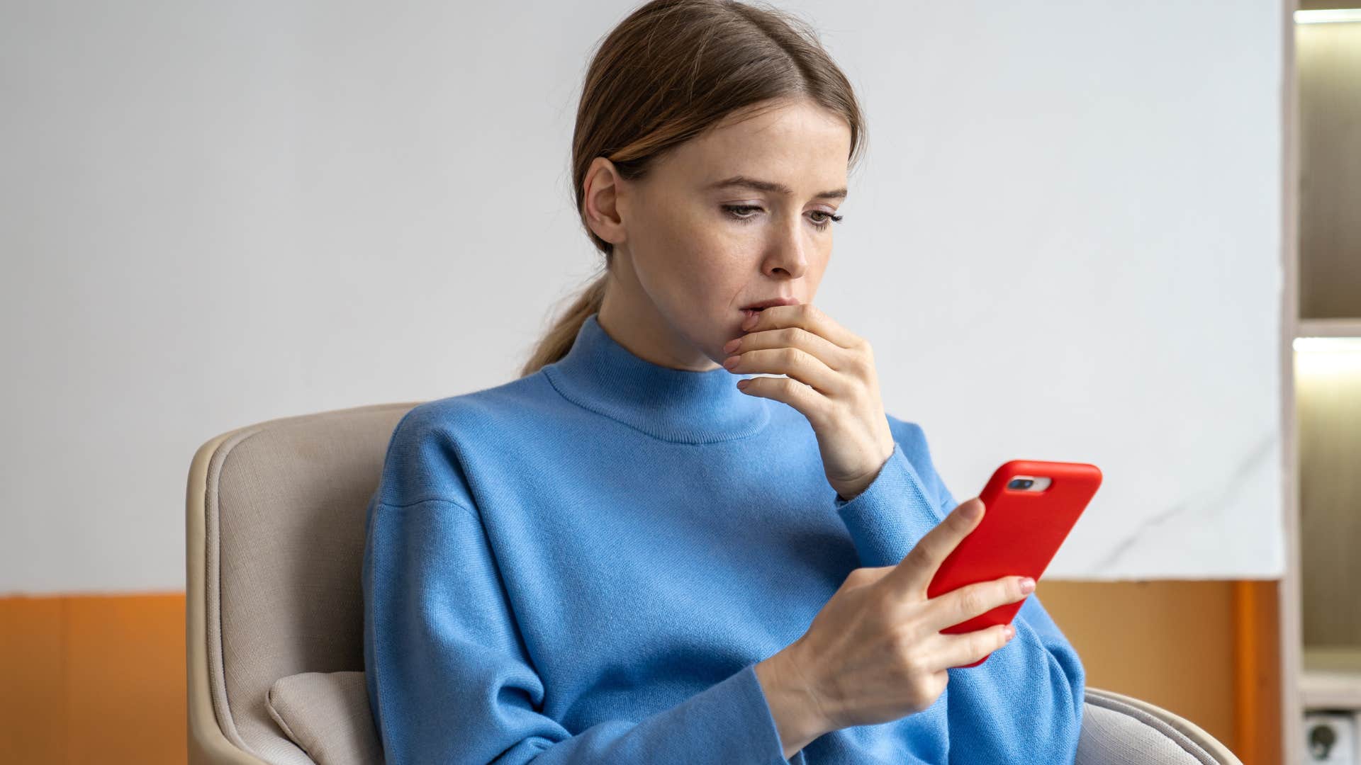 Woman looking at propaganda and fake news on her phone.