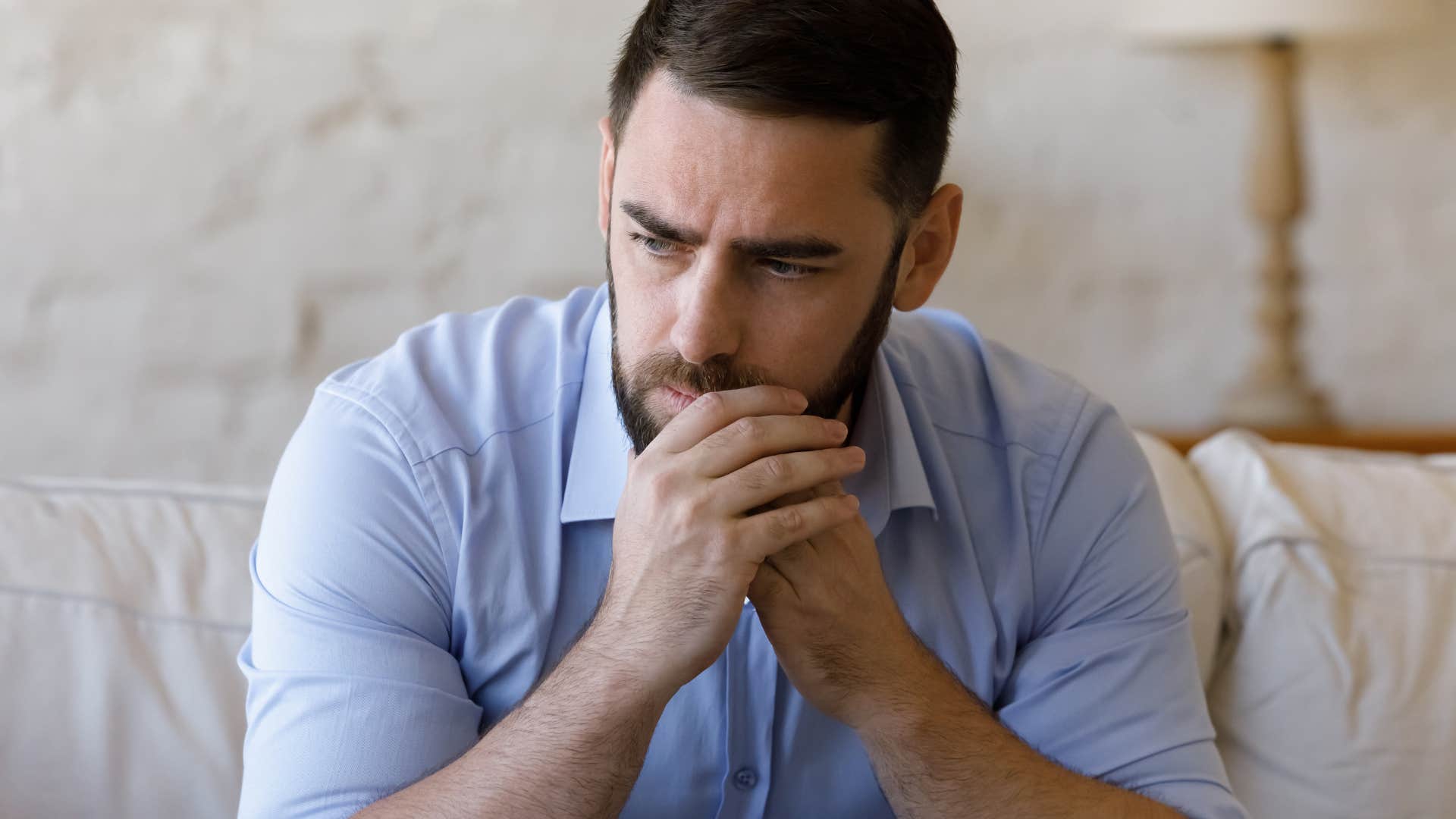 upset man sitting on couch