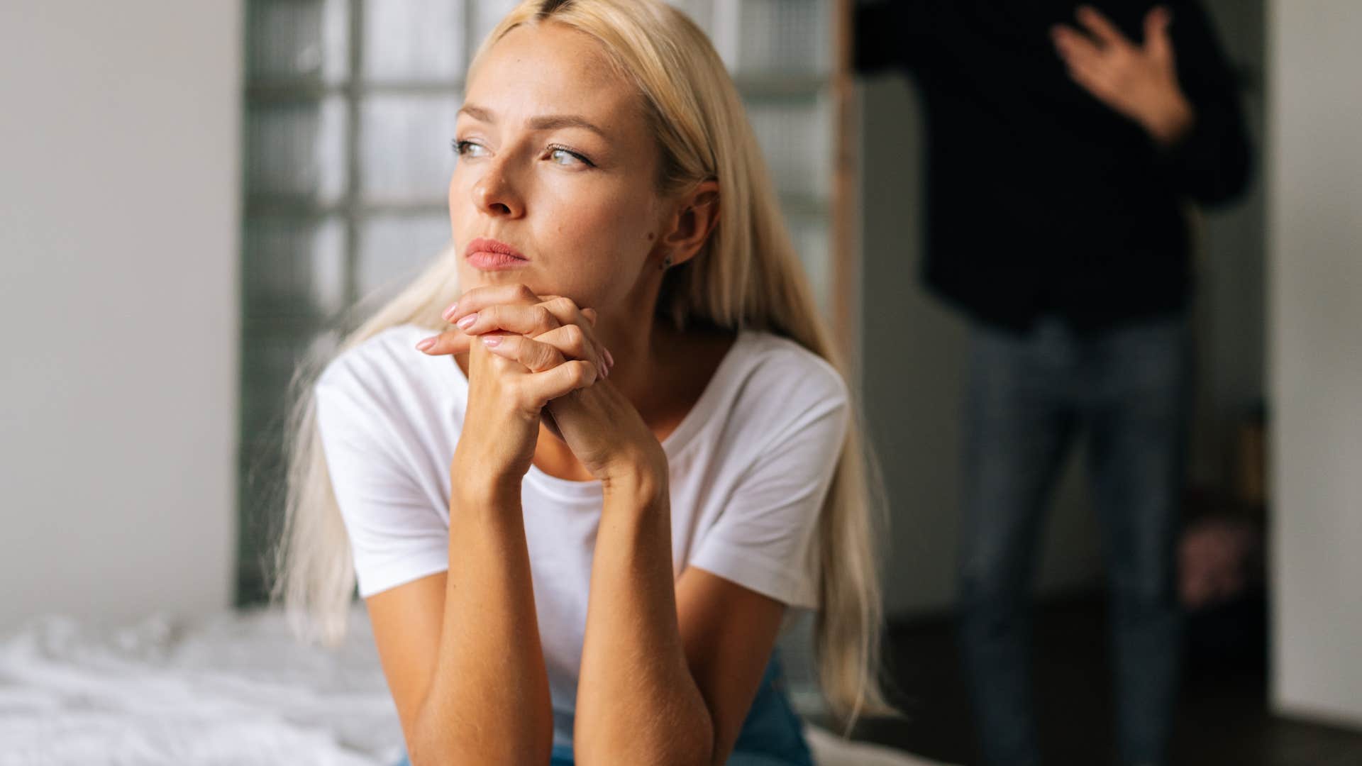 woman sitting in constant silence in her bedroom