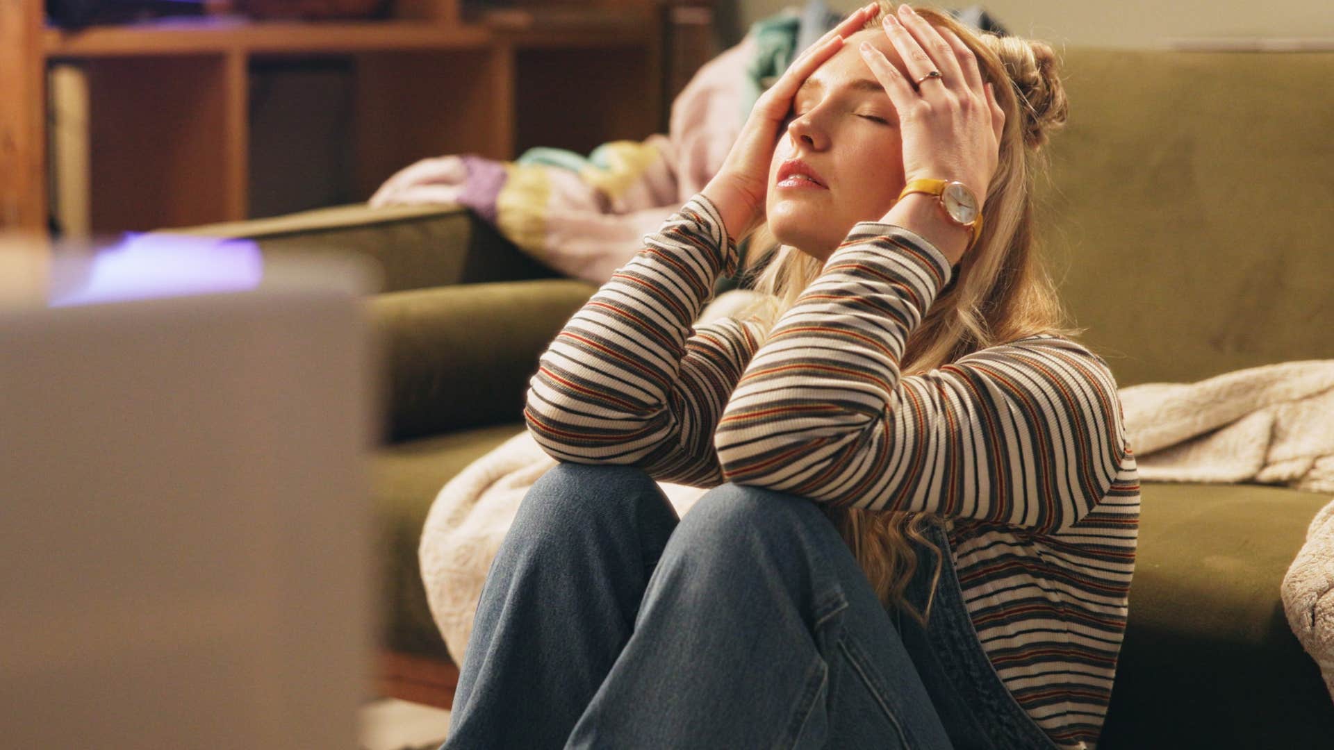 woman holding her head and thinking about her homes lack of individuality