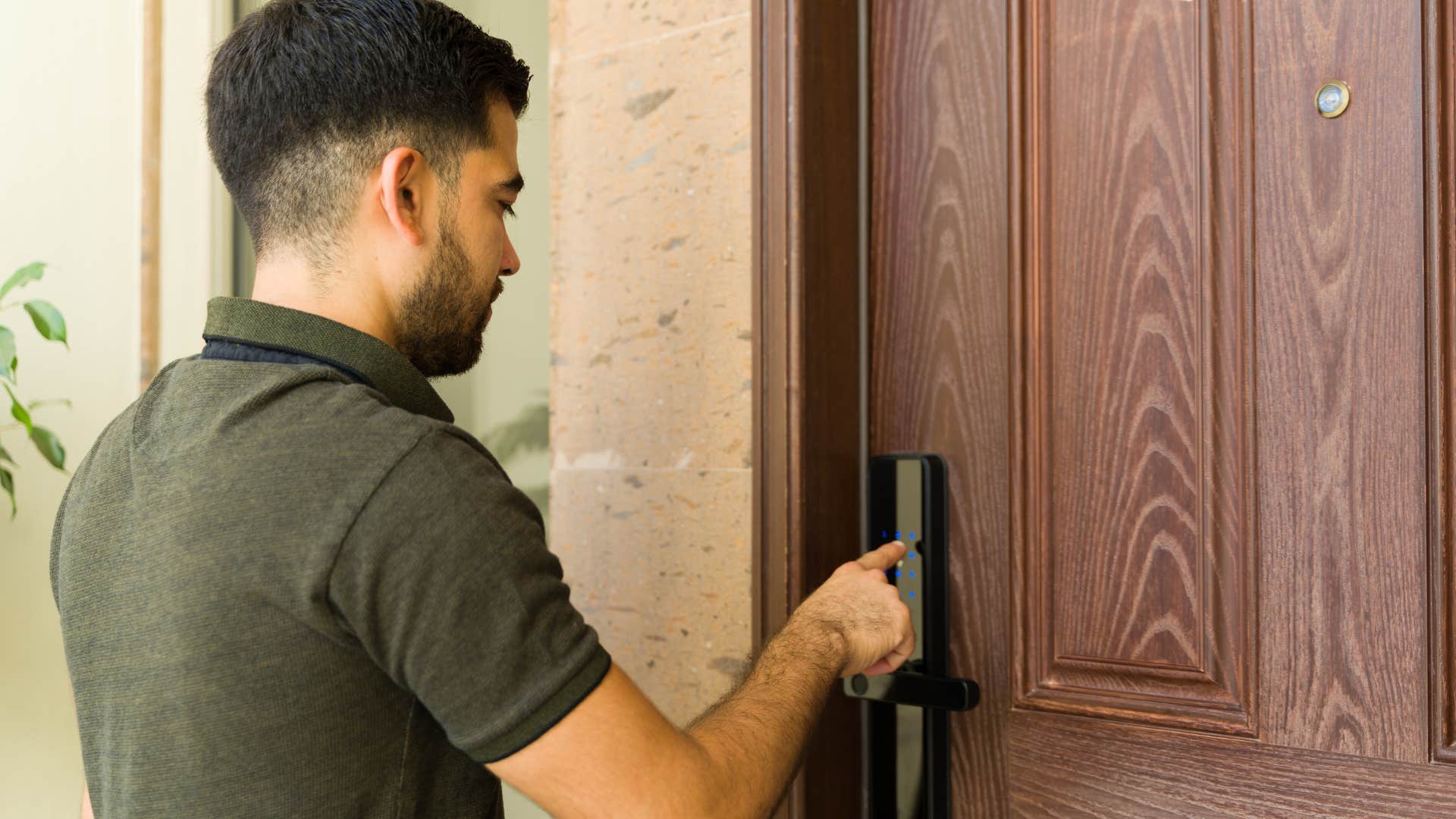 man shutting locked door at home