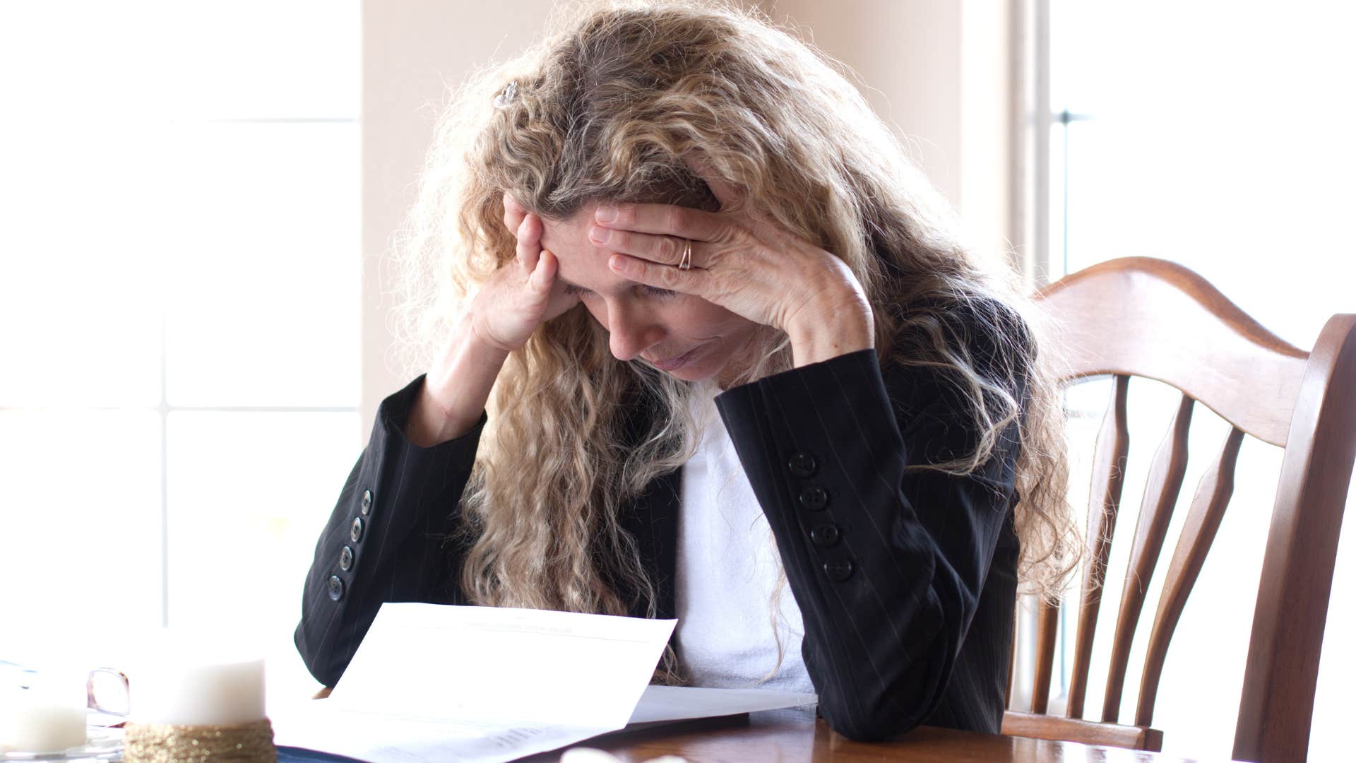 upset woman reading passive-aggressive note from partner
