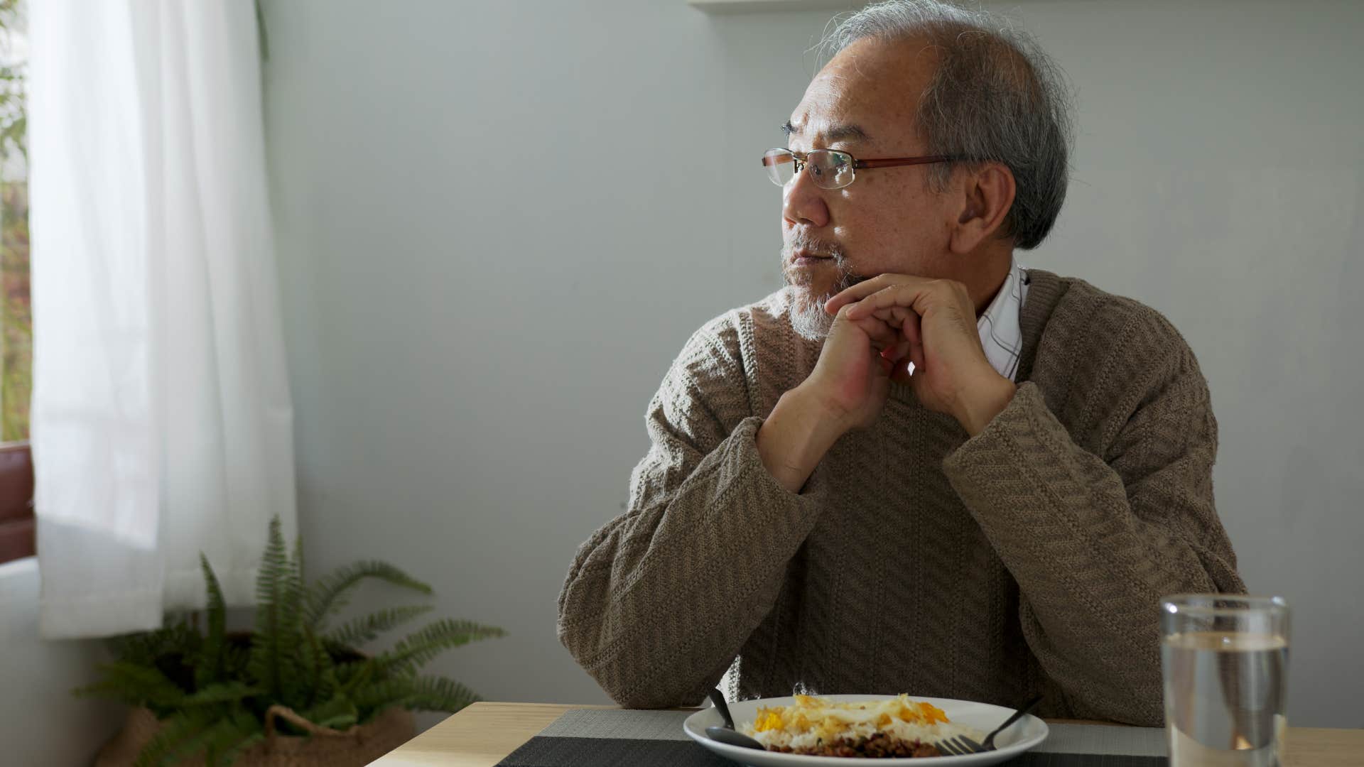 man with separate everything from his wife eating at home