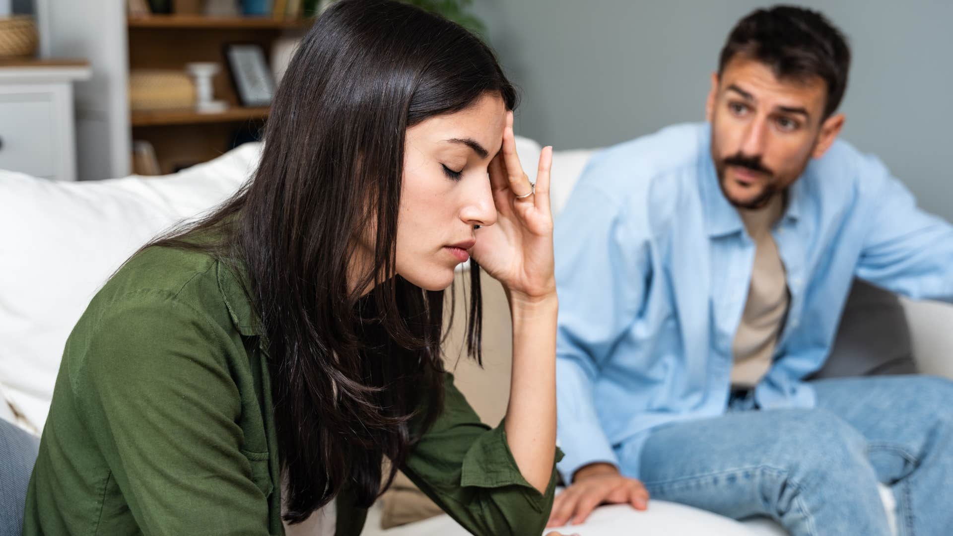 woman sitting in uncomfortable shared space with partner