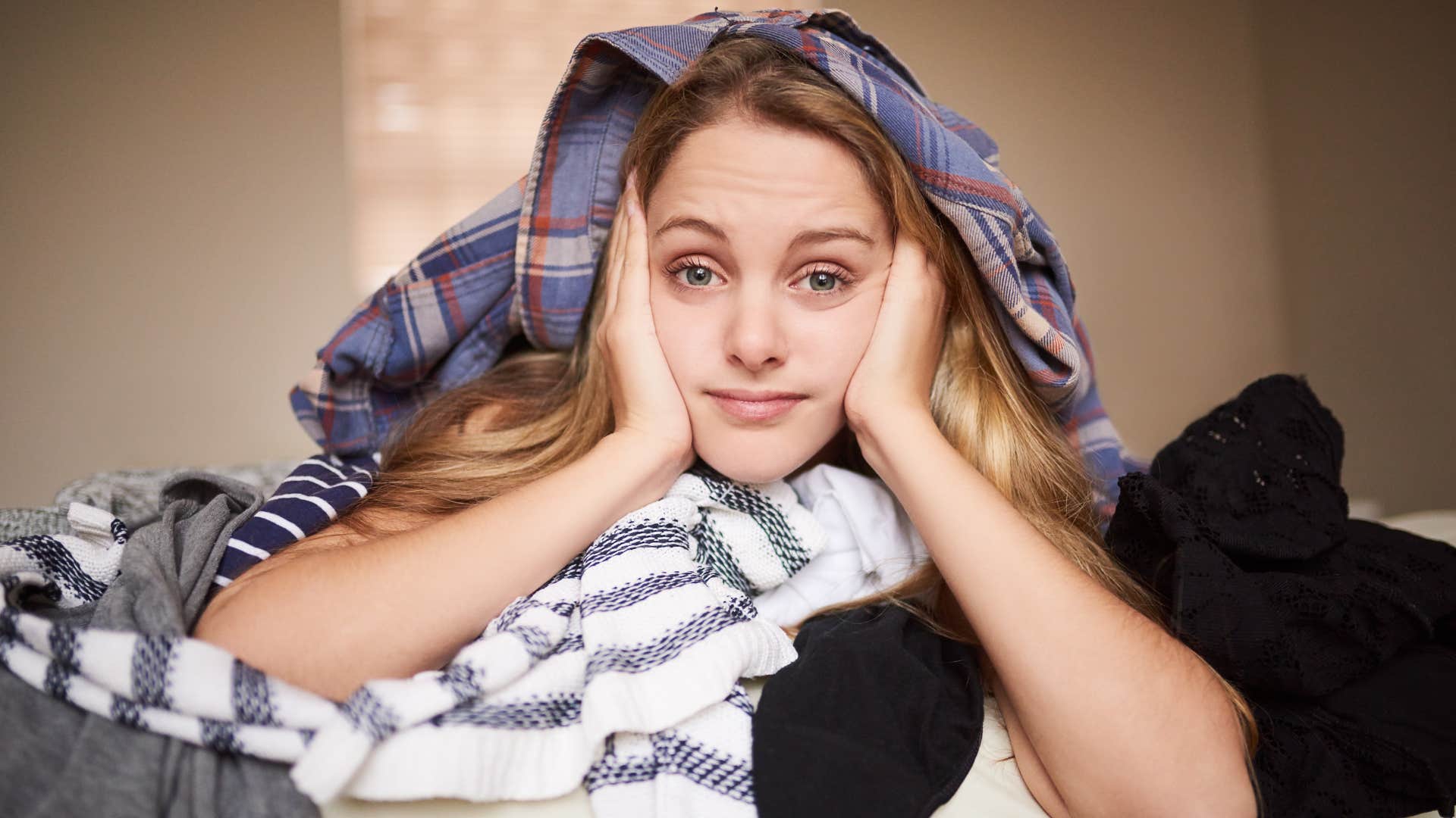 a woman just lays on her dirty pile of laundry instead of taking responsibility and washing it
