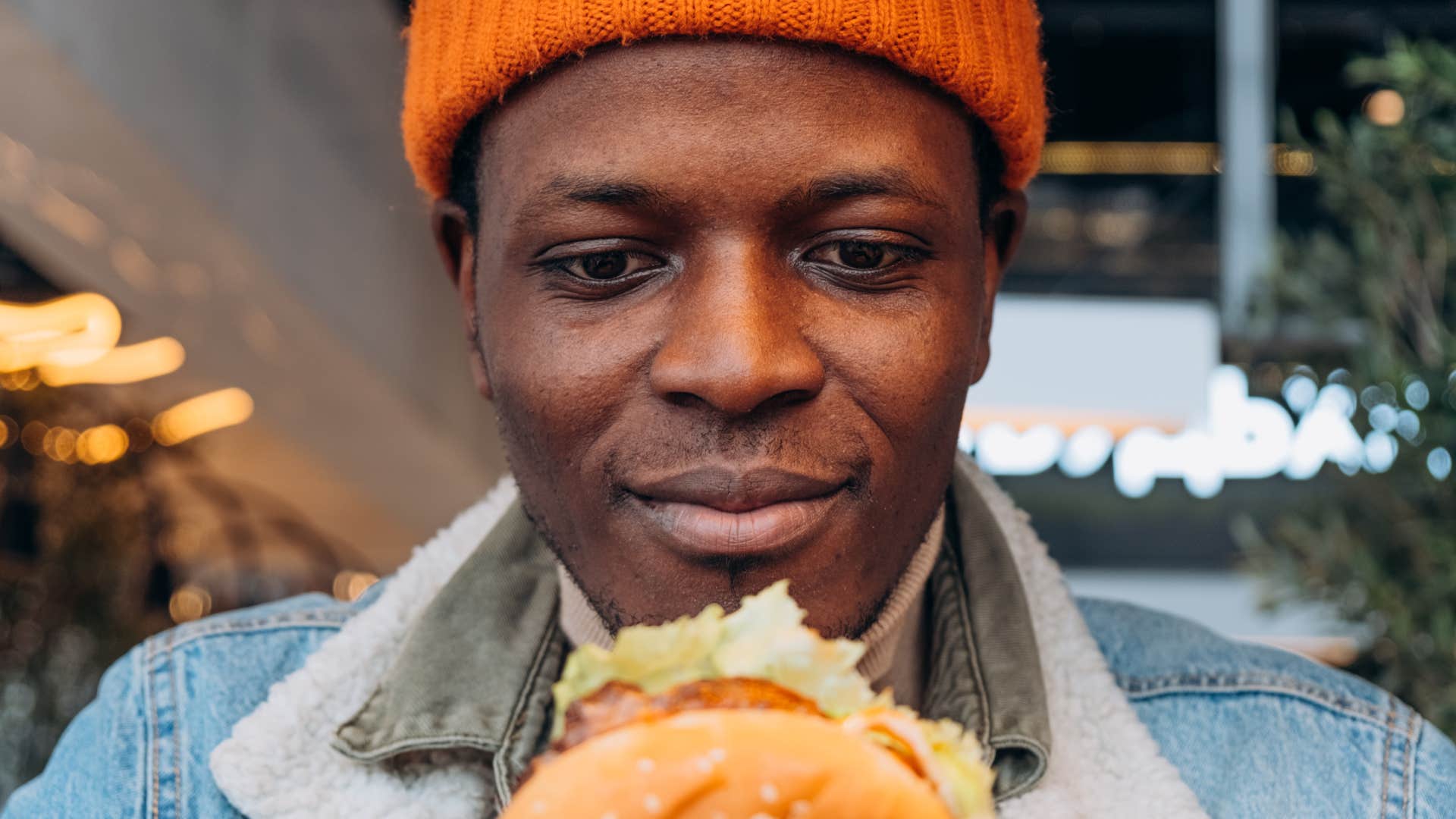 man eating comfort foods in his kitchen