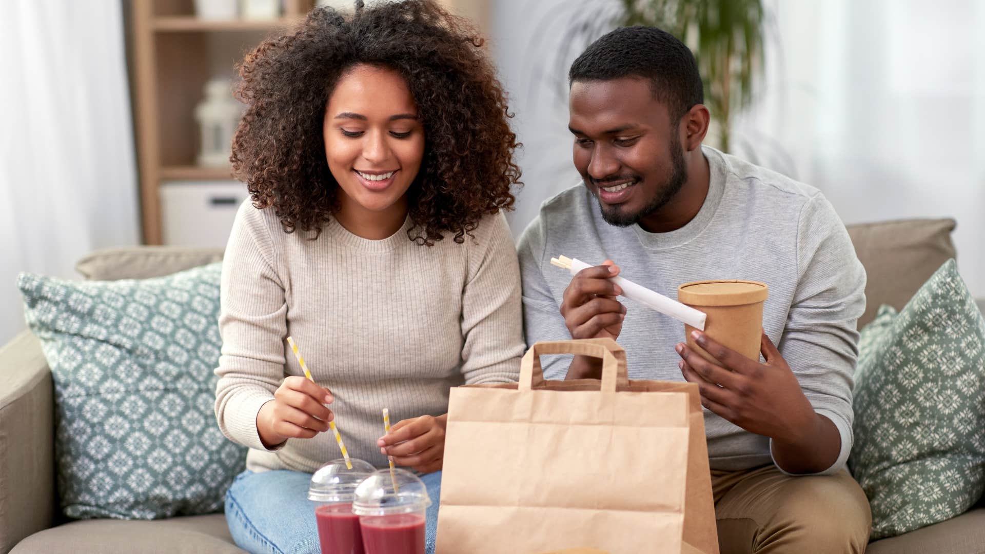 couple eating fast food with takeout containers