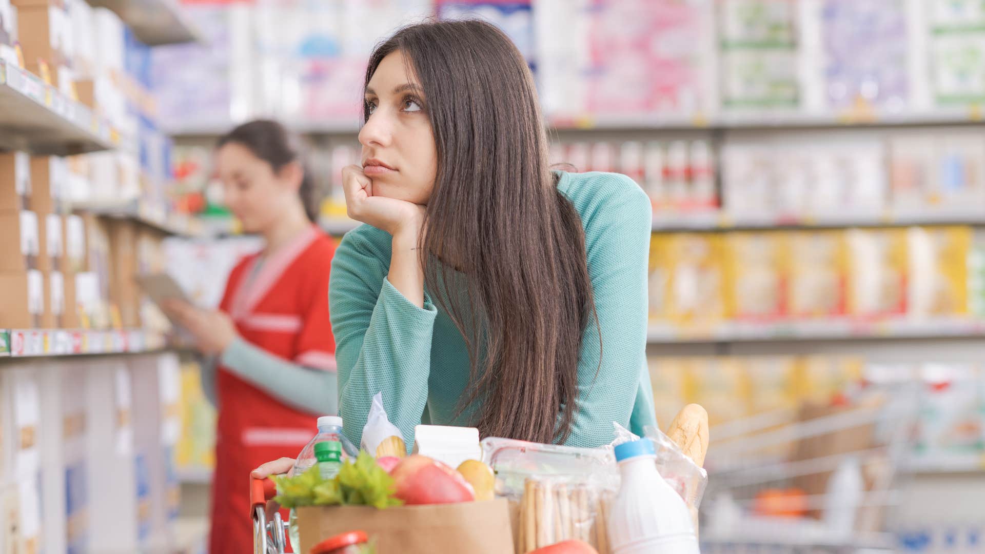 woman in blue shirt running short errands at grocery store