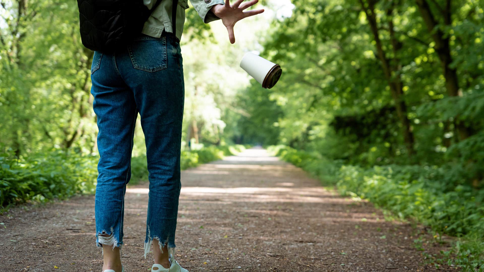 person walking alone littering