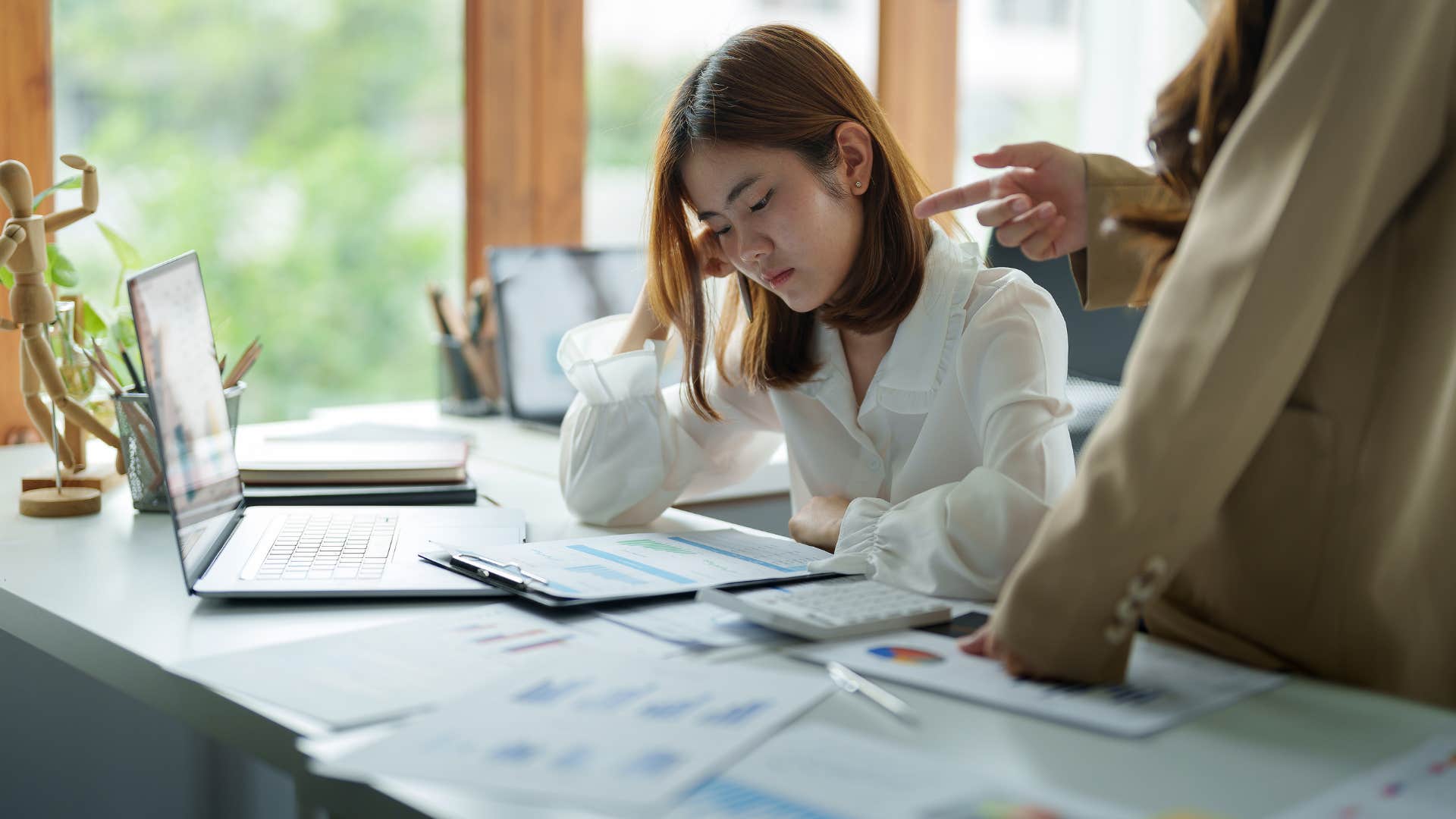woman dealing with passive-aggressive boss at work