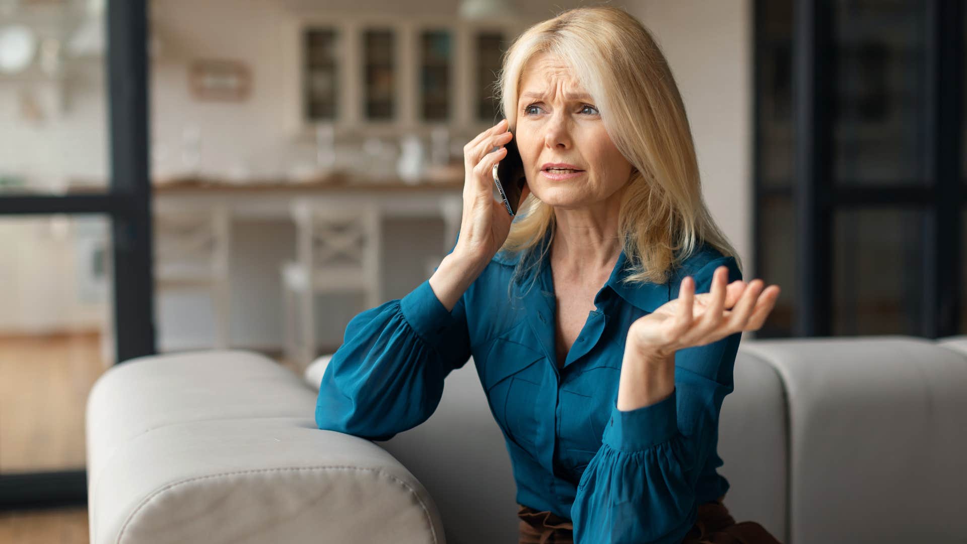 woman in blue shirt saying everyone sees things differently i guess on the phone while looking confused