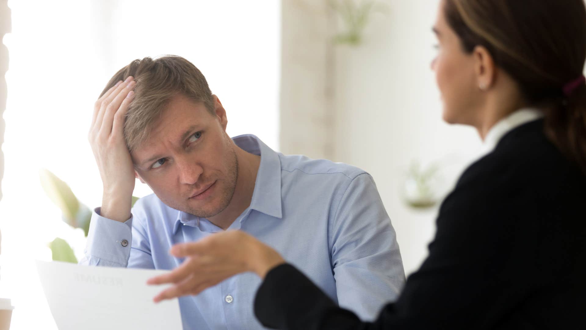 man in blue shirt looking confused and saying that must've been something as woman in suit continues talking