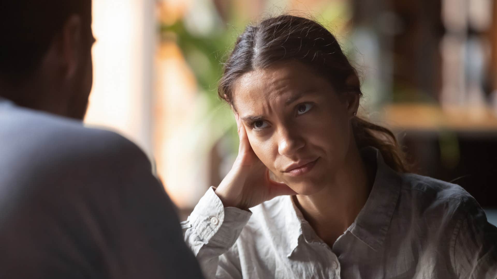 woman in gray shirt looking at man in confusion as she says i see