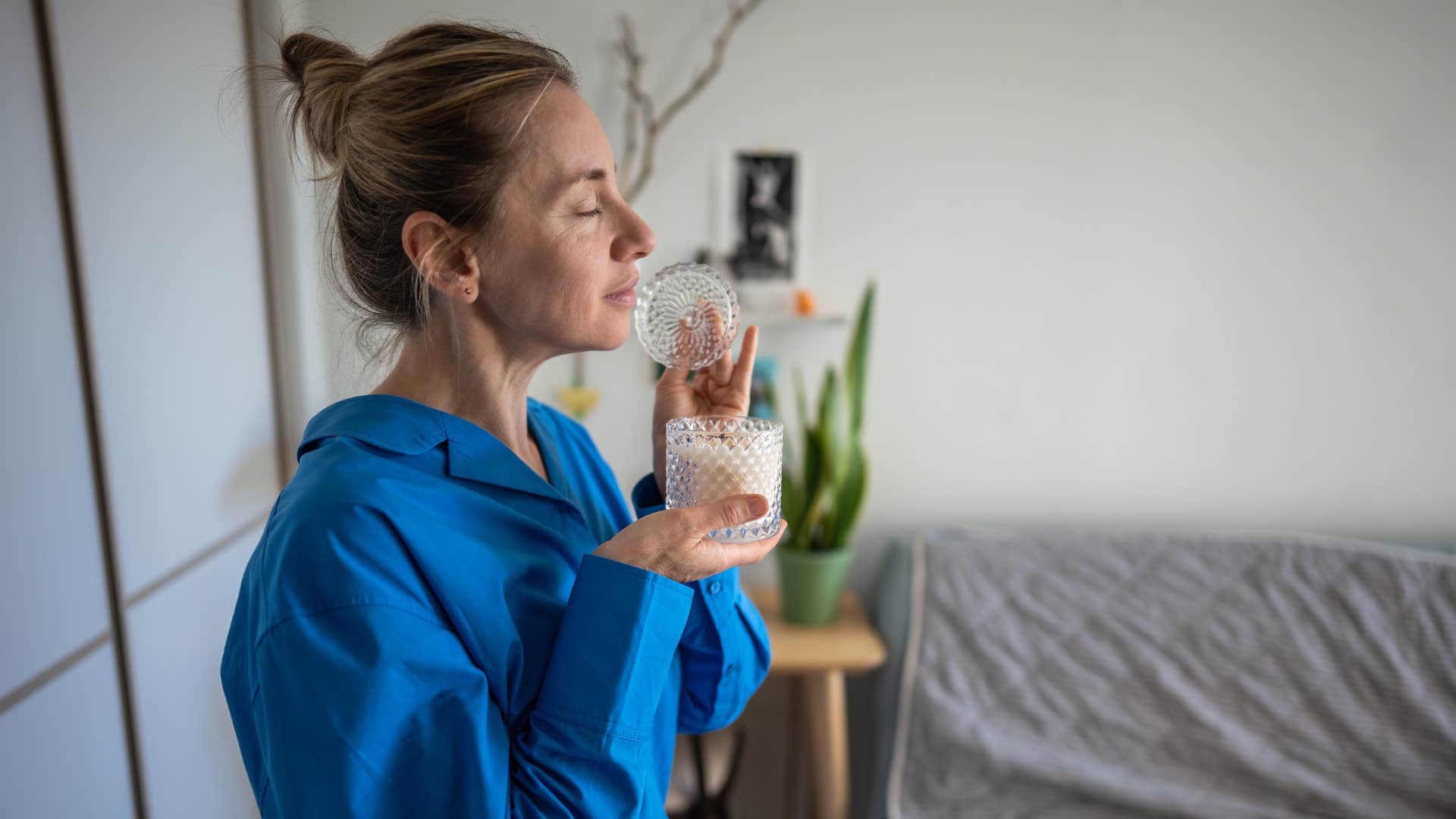 woman smelling calming candle