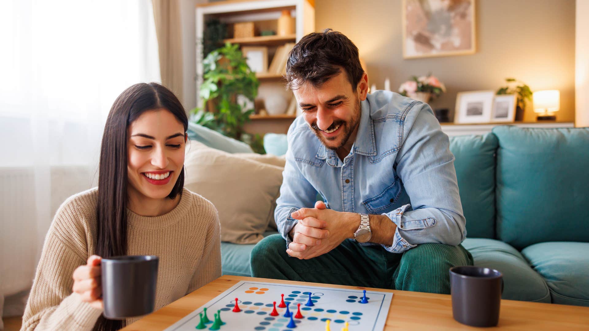 couple playing board games in living room