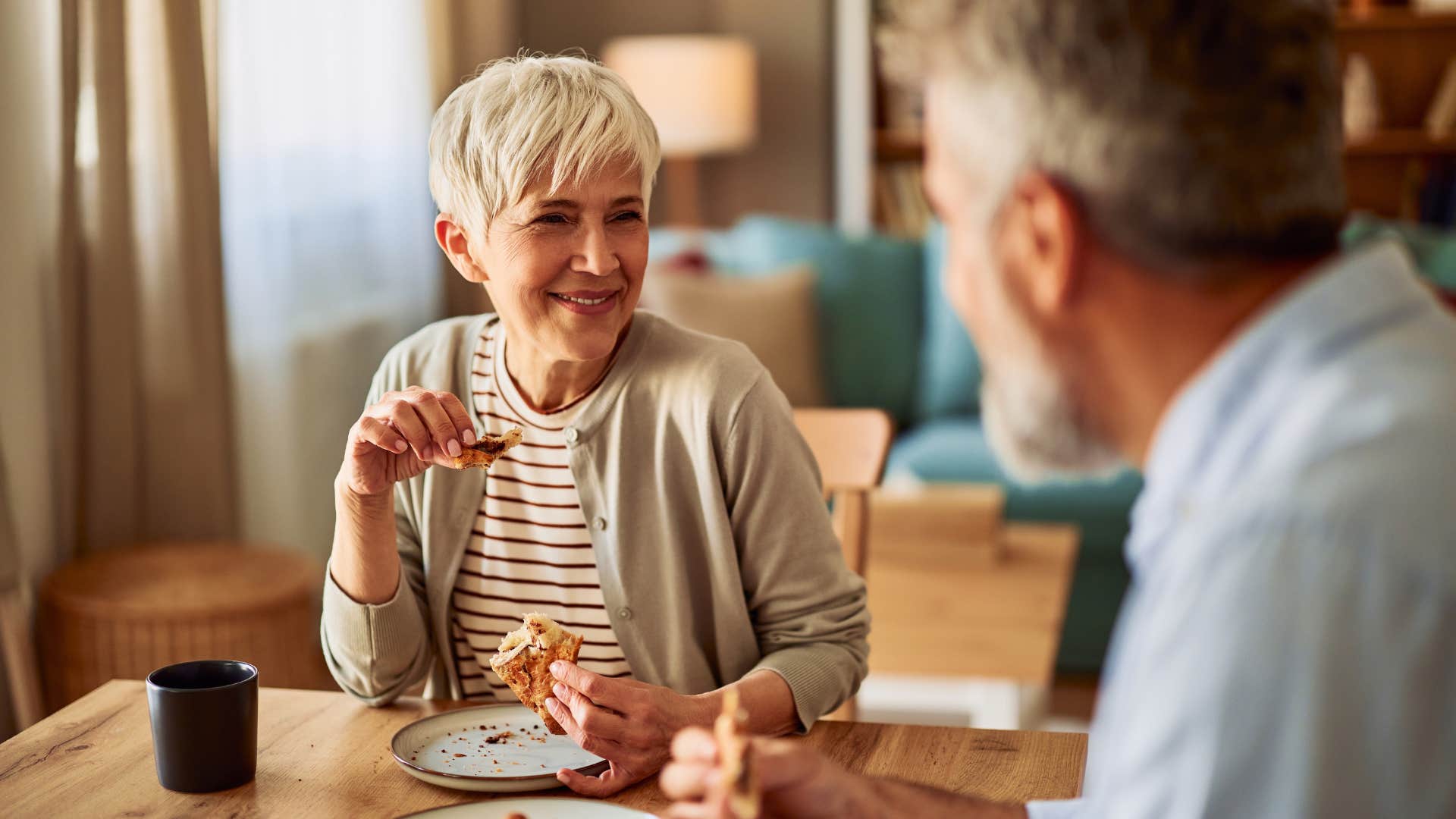 wife eating with husband at dining table