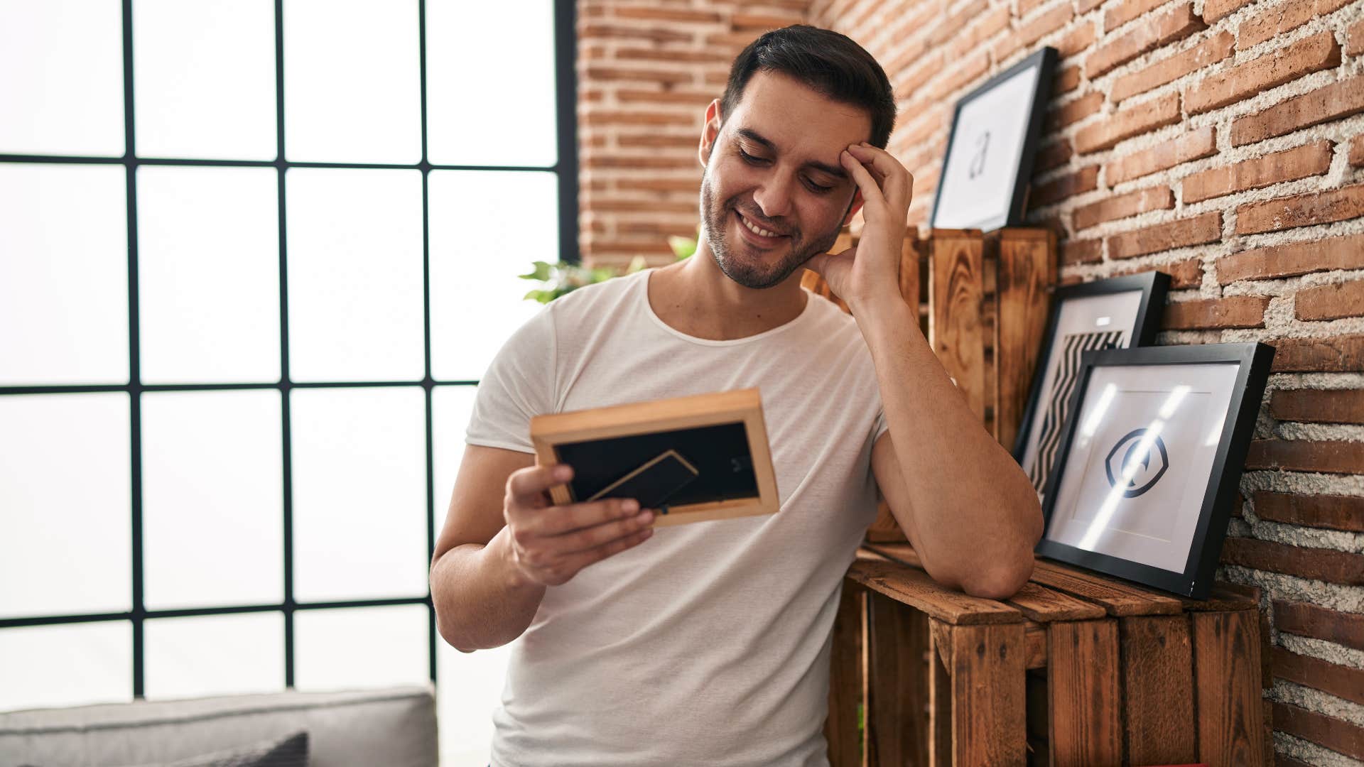 man looking at sentimental photos