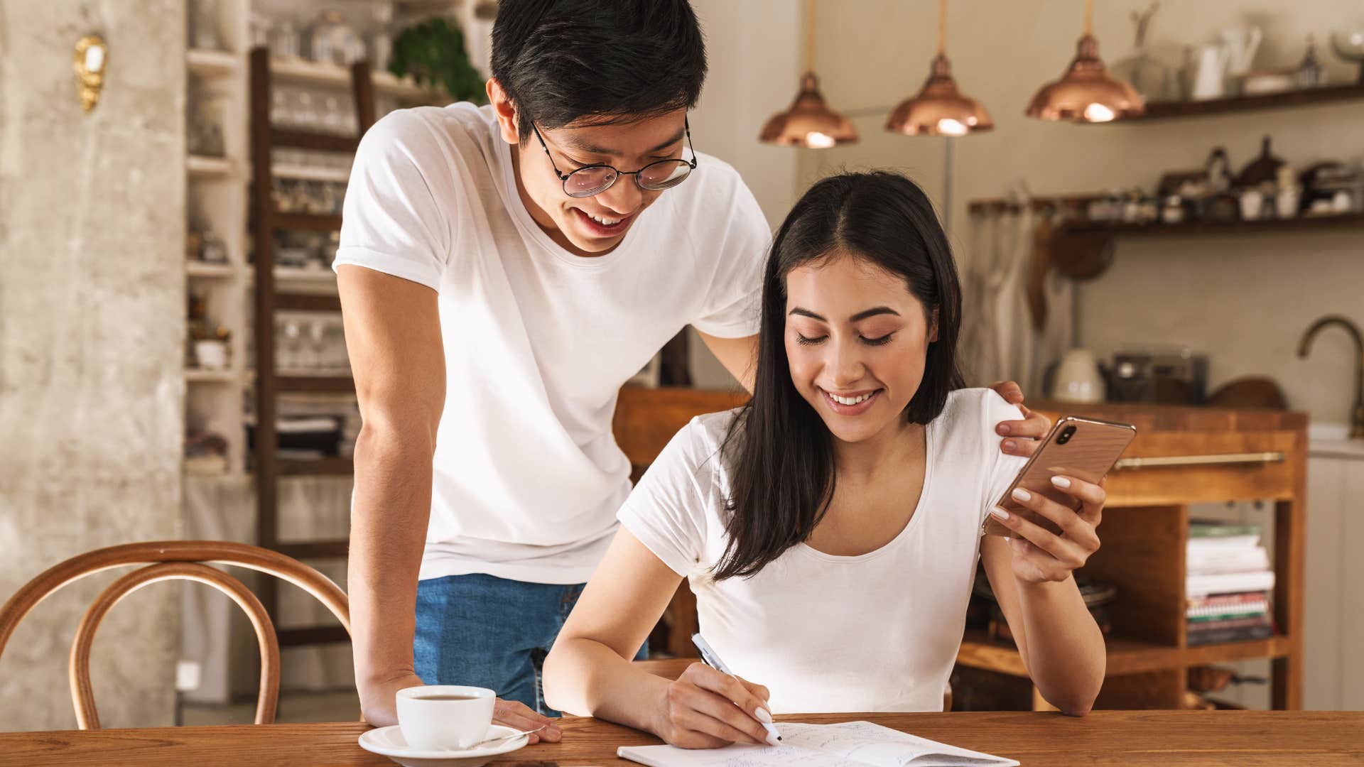 couple writing on shared calendar
