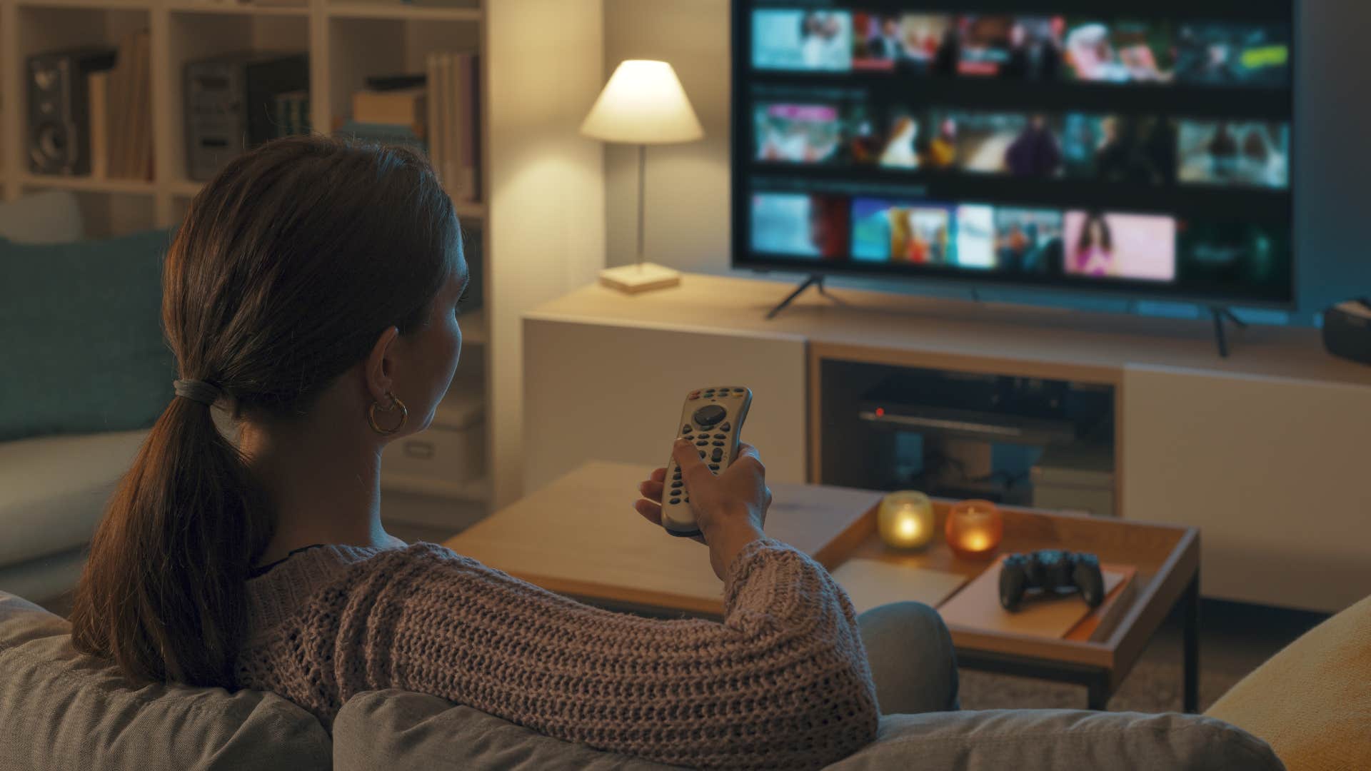 woman watching a giant tv filled with streaming services