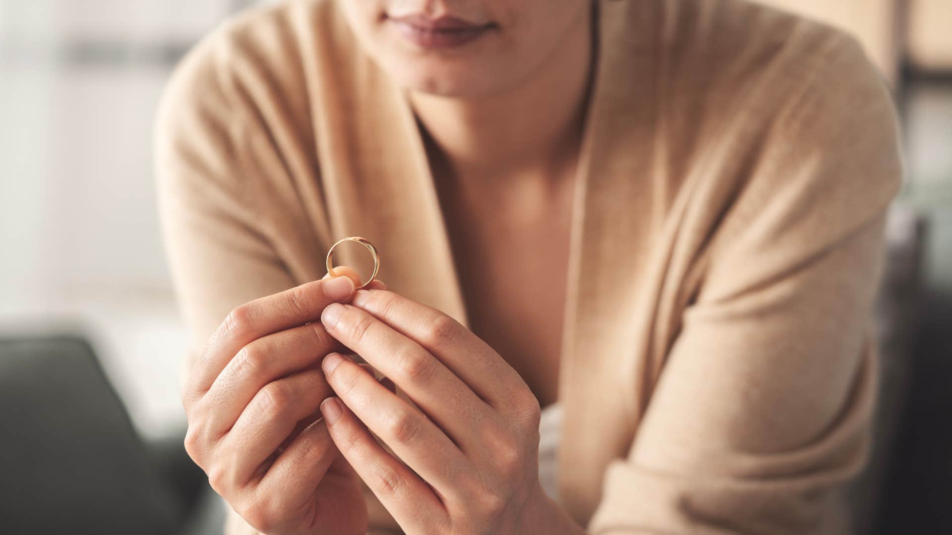 Woman putting her ring in a ring dish.